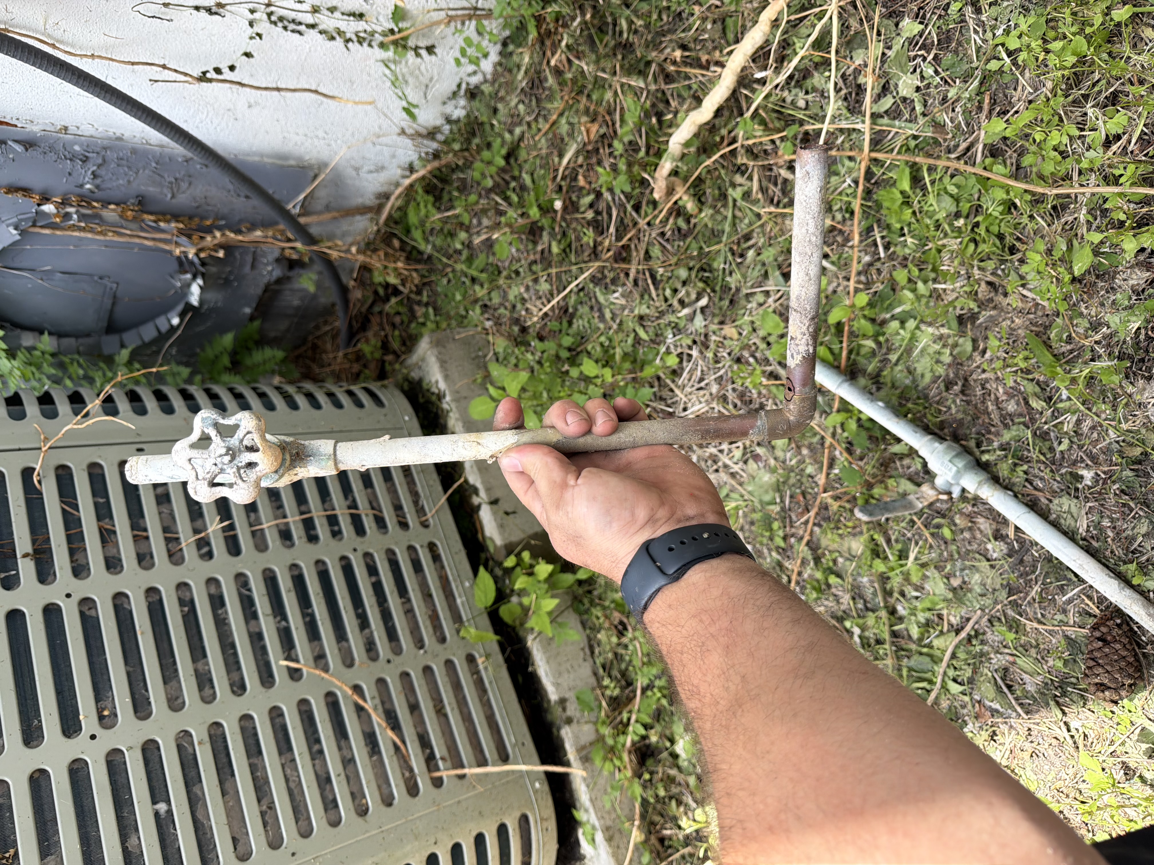 Exterior wall plumbing prepared for new shutoff valves during Clearwater emergency plumbing repair